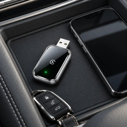 Homniva wireless CarPlay adapter in a car console tray beside a smartphone and car keys.